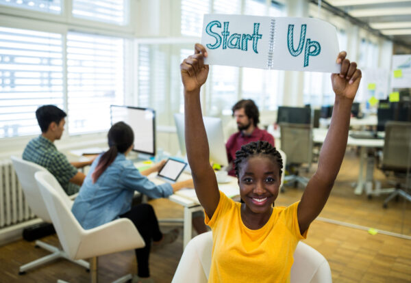 Portrait of female business executive start up sign in office