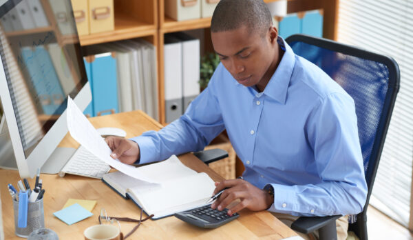Checking financial document Businessman concentrated on work with financial document