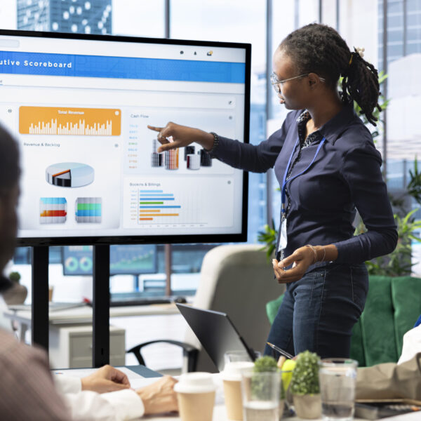 Advisory board members and team leaders gathering to review project outcomes, discuss resource allocation to ensure objectives achievement. Diverse business associates in a meeting.