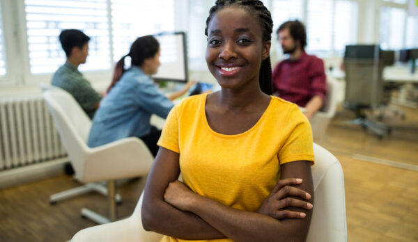 Female graphic designer sitting with arms crossed Female graphic designer sitting with arms crossed in office