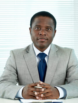 Successful businessman Portrait of confident African businessman looking at camera in office