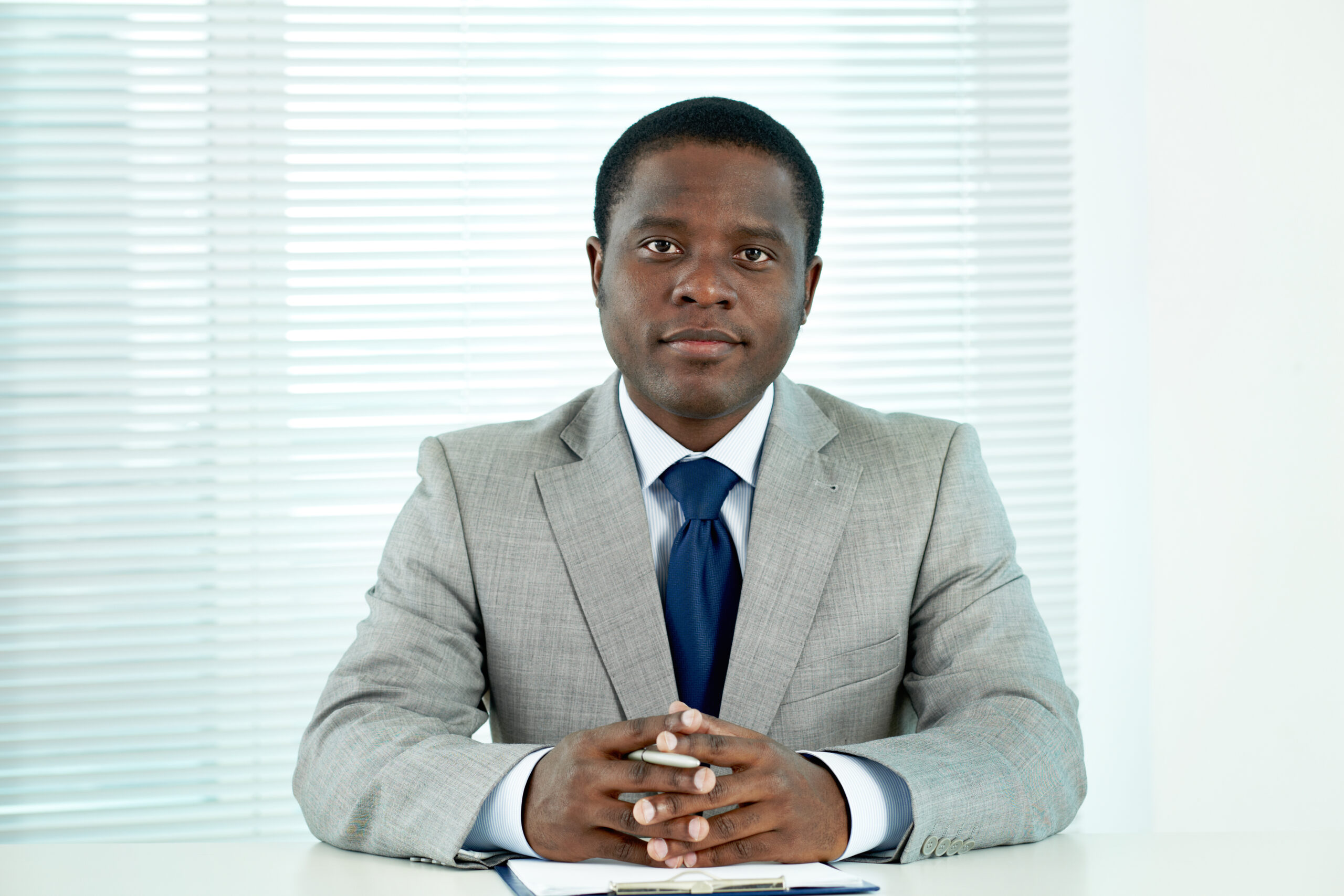 Portrait of confident African businessman looking at camera in office
